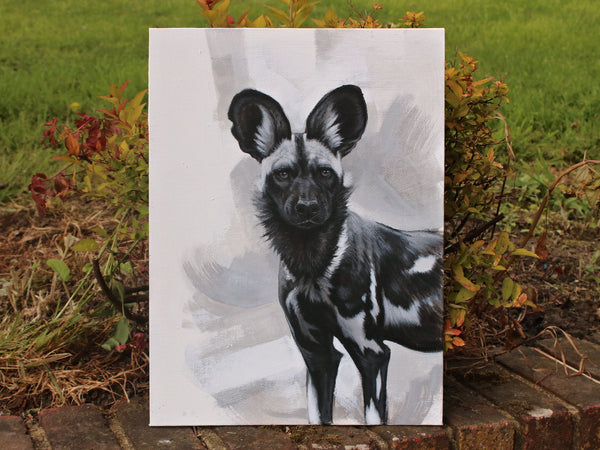 Painted Dog mixed media painting on board propped on a wall