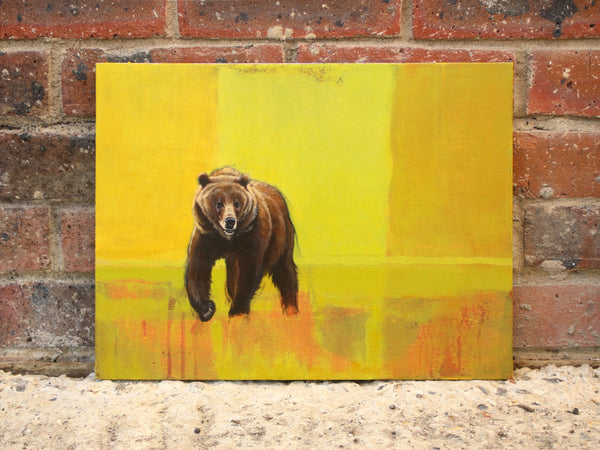 Grizzly bear painting on canvas board propped up by a wall