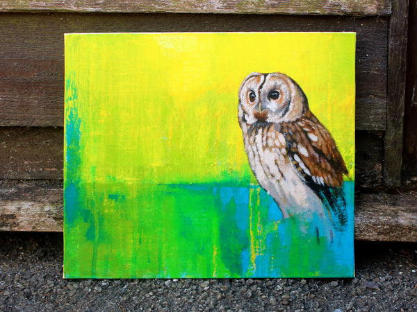 Tawney owl painting with a bright background propped up against wall
