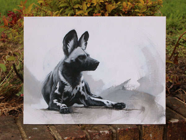 Black and white Painted Dog painting on board propped up on wall